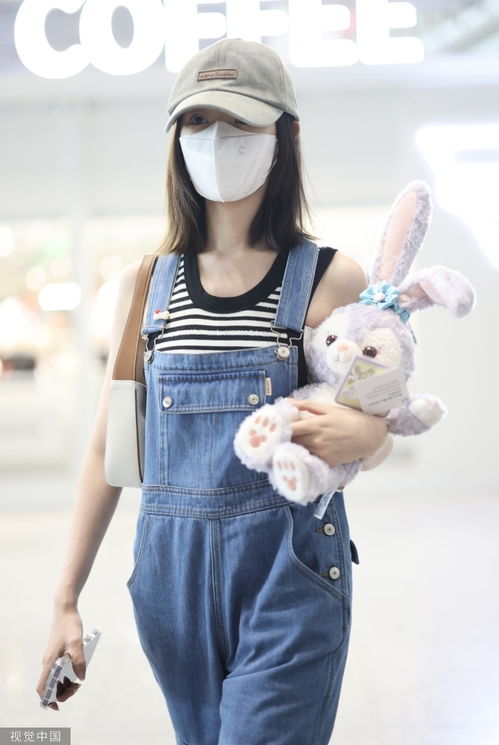 毛晓彤穿背带牛仔裤抵达机场手抱星黛露少女感满满